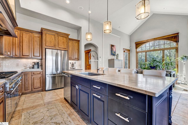 kitchen featuring brown cabinets, stainless steel appliances, tasteful backsplash, hanging light fixtures, and a sink