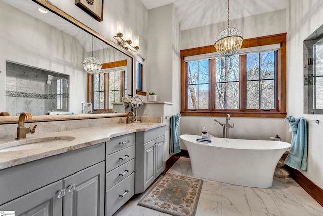 full bath featuring marble finish floor, a notable chandelier, a sink, and double vanity