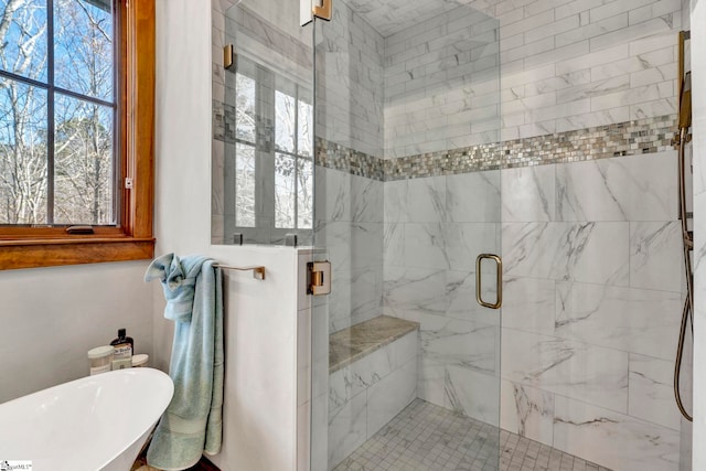 bathroom with a freestanding tub and a shower stall