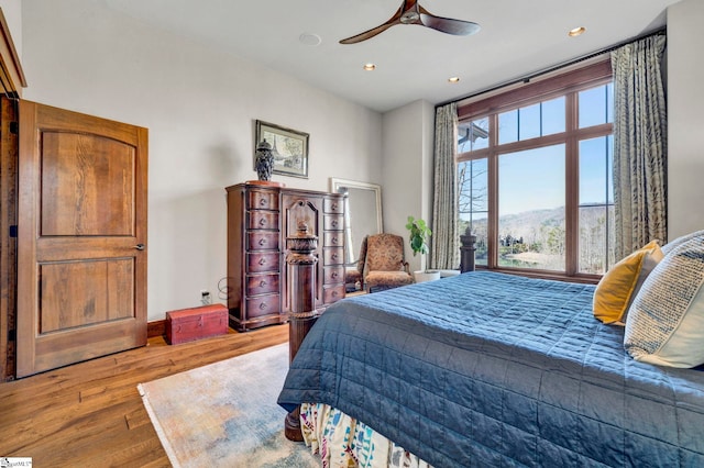 bedroom with a ceiling fan, baseboards, wood finished floors, and recessed lighting