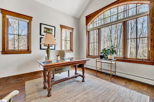 office with a wealth of natural light, a baseboard radiator, visible vents, and vaulted ceiling