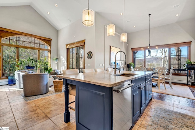 kitchen with high vaulted ceiling, stainless steel dishwasher, a sink, and pendant lighting