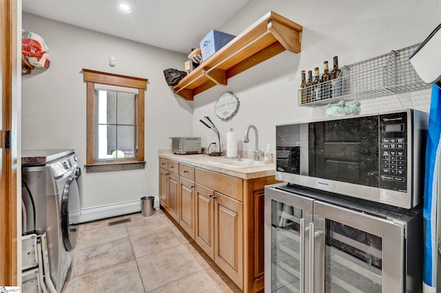 kitchen with beverage cooler, separate washer and dryer, open shelves, a sink, and light tile patterned flooring