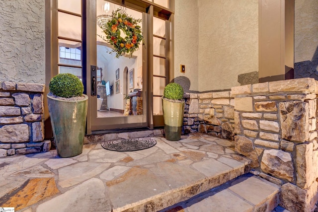 property entrance with stucco siding