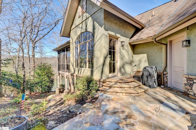 view of patio featuring a sunroom