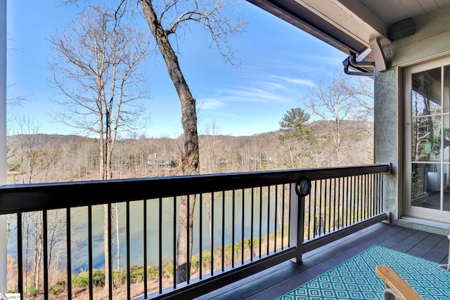 wooden deck featuring a forest view