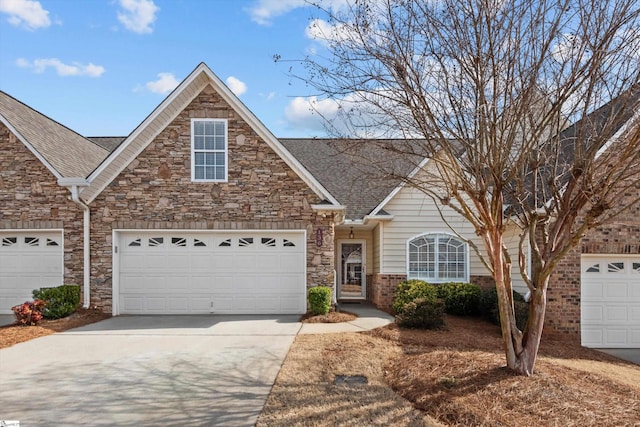 traditional-style house featuring a garage, brick siding, driveway, and a shingled roof