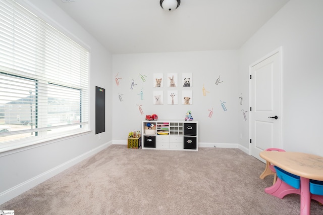 recreation room with carpet floors and baseboards