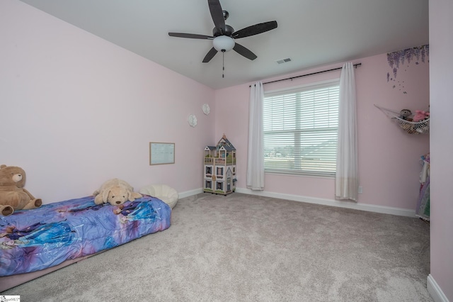 bedroom featuring carpet floors, a ceiling fan, visible vents, and baseboards