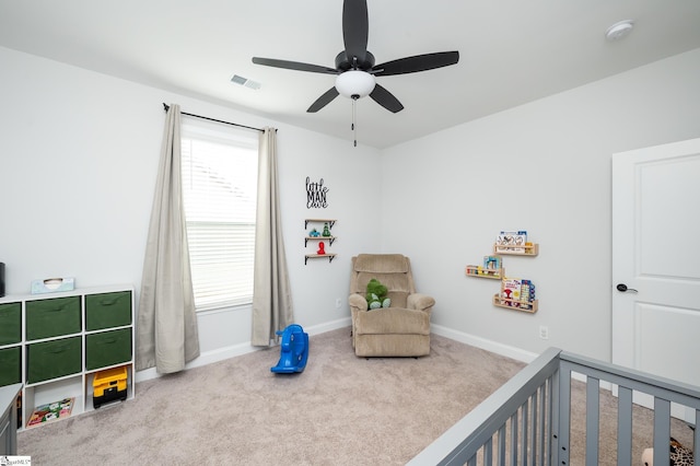 carpeted bedroom with a nursery area, ceiling fan, visible vents, and baseboards