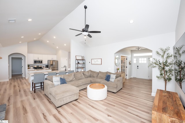 living area with visible vents, arched walkways, ceiling fan, light wood-style flooring, and recessed lighting