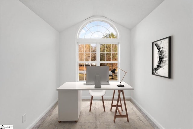 home office with lofted ceiling and baseboards