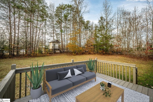 wooden terrace with an outdoor living space and a yard