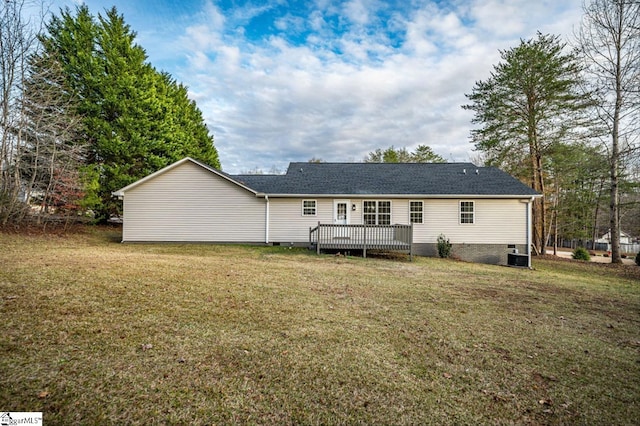 rear view of property featuring a yard, crawl space, and a wooden deck