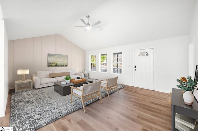 living room with lofted ceiling, a ceiling fan, and wood finished floors