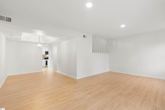 unfurnished room with light wood-style flooring, recessed lighting, visible vents, and baseboards