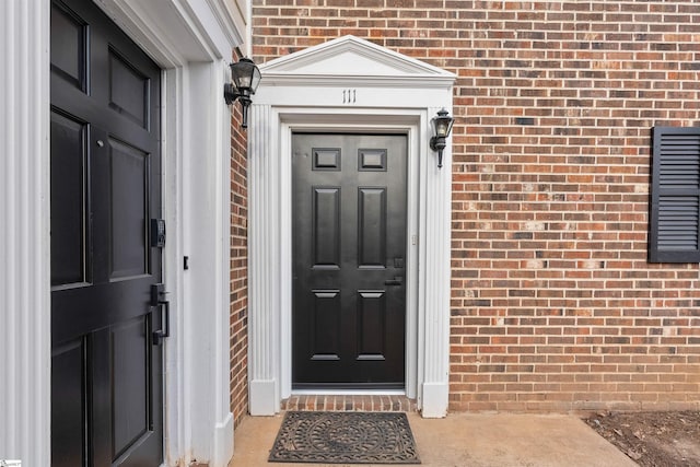 entrance to property with brick siding