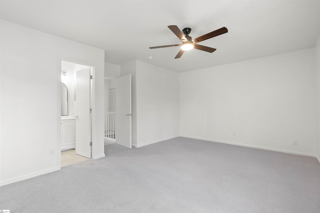 unfurnished bedroom with a ceiling fan, carpet flooring, connected bathroom, and baseboards