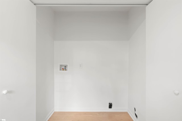 laundry area with hookup for a washing machine, laundry area, light wood-style floors, and baseboards