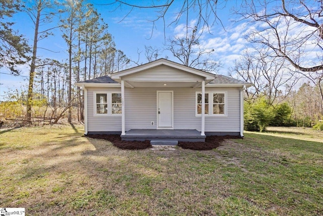 view of front of property with a porch and a front lawn