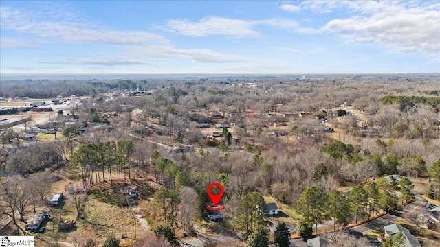 bird's eye view featuring a wooded view