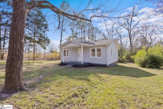 view of front of home featuring covered porch and a front lawn