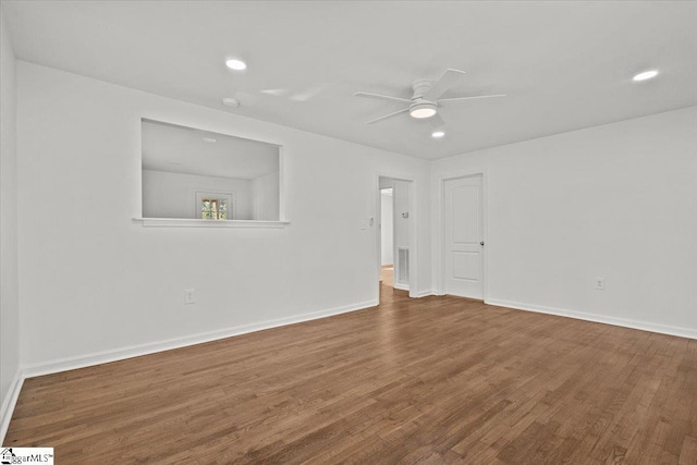 spare room with ceiling fan, recessed lighting, wood finished floors, and baseboards