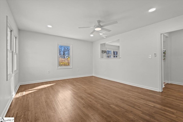 unfurnished room featuring dark wood-type flooring, recessed lighting, and plenty of natural light