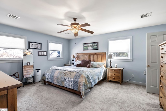 carpeted bedroom with ceiling fan, visible vents, and baseboards