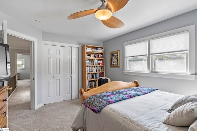 carpeted bedroom featuring a ceiling fan and a closet