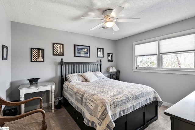 carpeted bedroom featuring baseboards, visible vents, ceiling fan, and a textured ceiling