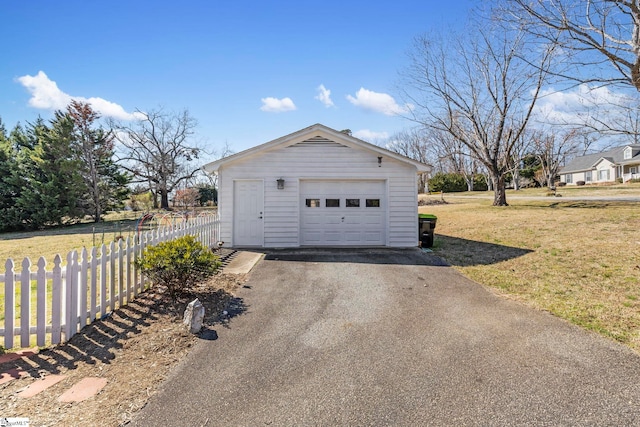 detached garage with fence and driveway