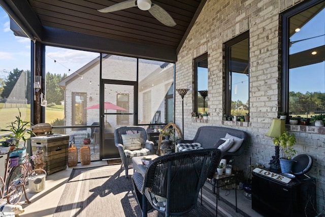 sunroom / solarium with lofted ceiling, a healthy amount of sunlight, and ceiling fan