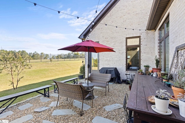 view of patio featuring fence and area for grilling