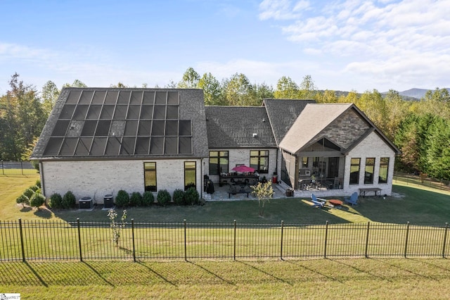 back of house featuring central AC unit, a lawn, a patio area, and fence