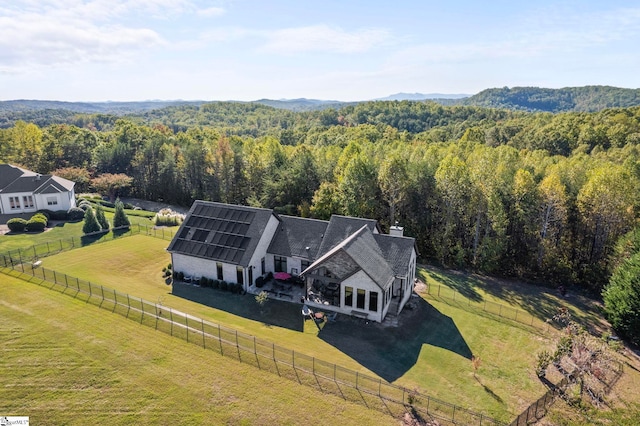 aerial view featuring a forest view and a rural view