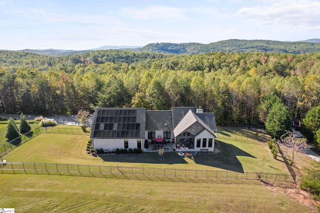 birds eye view of property with a mountain view and a forest view