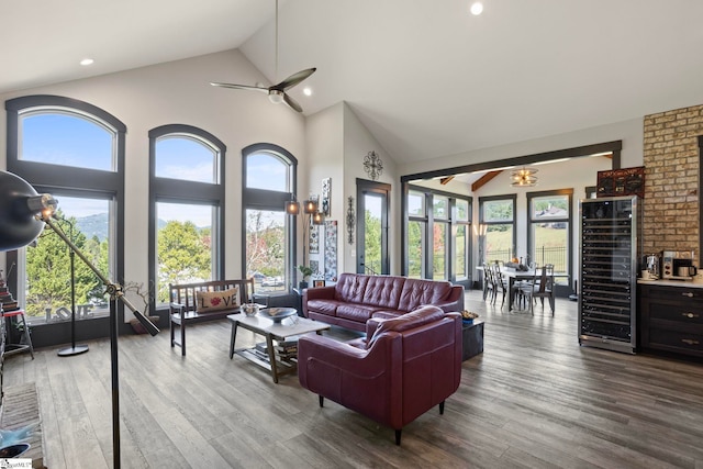 living room featuring a wealth of natural light, ceiling fan, wine cooler, and wood finished floors