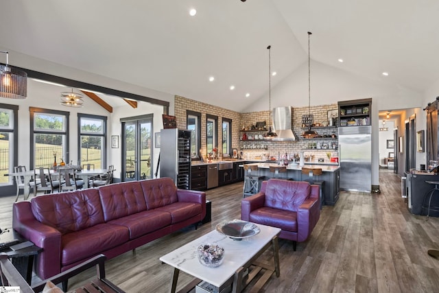 living room featuring high vaulted ceiling, recessed lighting, brick wall, dark wood-style flooring, and bar area