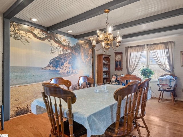 dining area featuring a chandelier, wood finished floors, and beamed ceiling