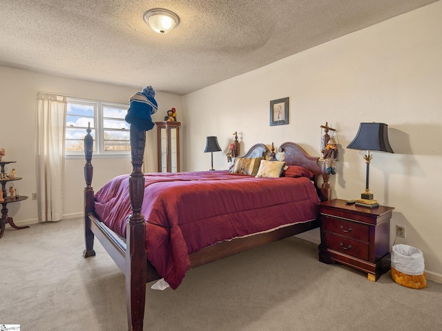 bedroom with a textured ceiling, baseboards, and carpet flooring