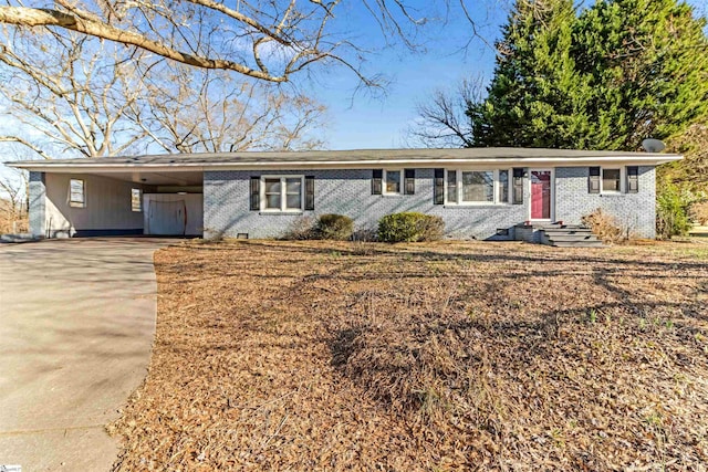 single story home with an attached carport, concrete driveway, and brick siding