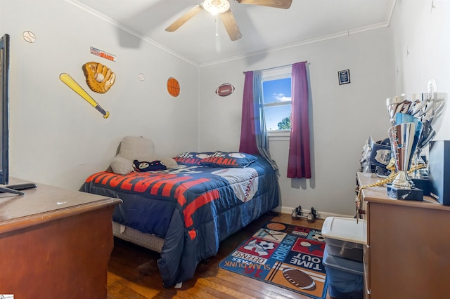 bedroom with baseboards, wood-type flooring, ornamental molding, and a ceiling fan