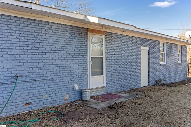 exterior space featuring crawl space and brick siding