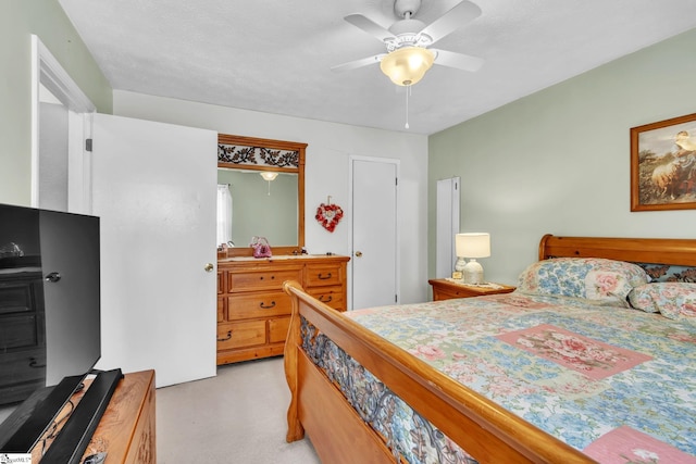 bedroom with light carpet and ceiling fan