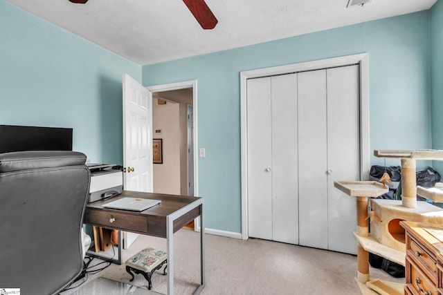 office space featuring a ceiling fan, a textured ceiling, and baseboards