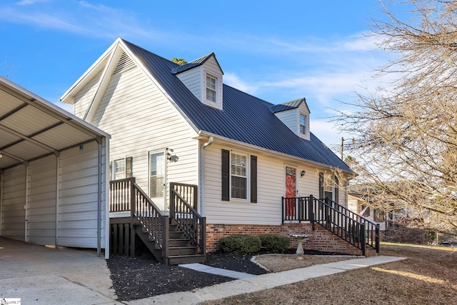 view of front of house featuring metal roof and a detached carport