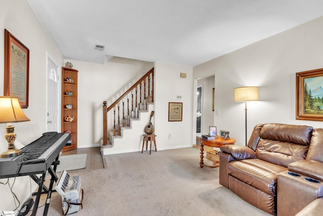 carpeted living area with stairway, visible vents, and baseboards