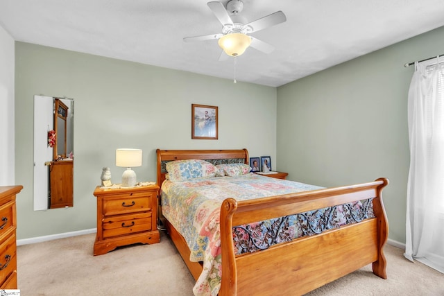 carpeted bedroom with ceiling fan and baseboards