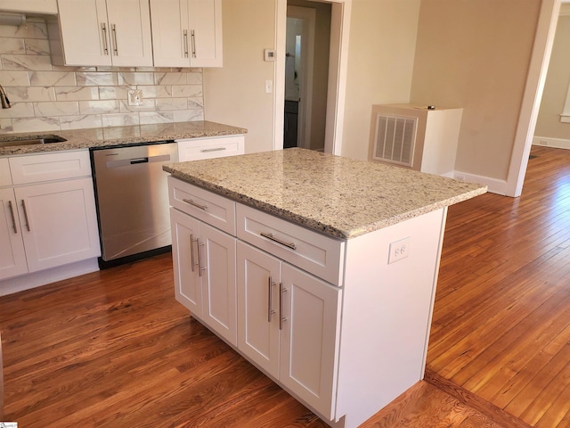 kitchen featuring dishwasher, a sink, dark wood finished floors, and visible vents